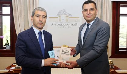 Afyon Belediye Başkan Yardımcısı Kasapoğlu kitabını Vali Aktaş'a takdim etti
